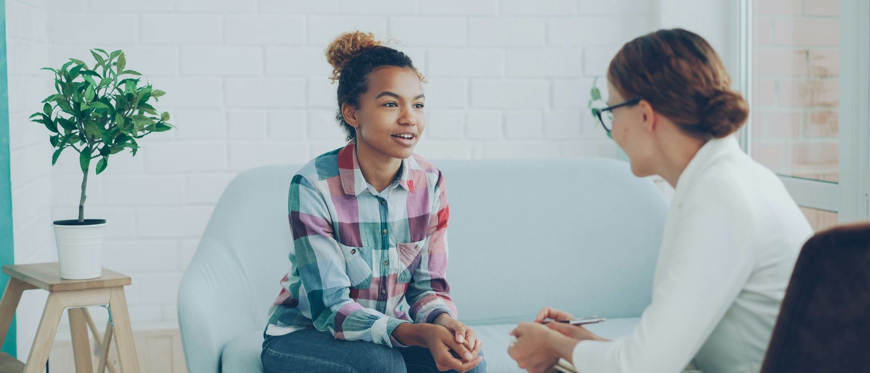 A young woman talking with a counsellor in a bright, calm room